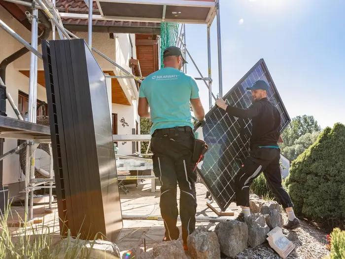 Installers carry solar module