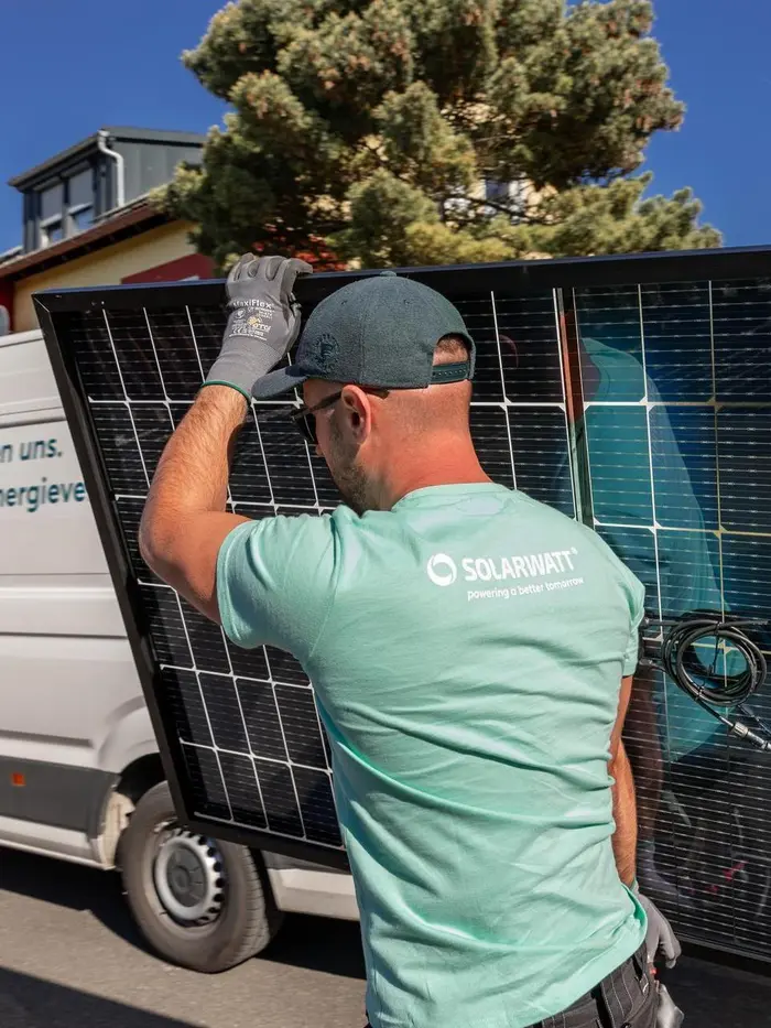 Solarwatt-Installateur trägt Solarmodul