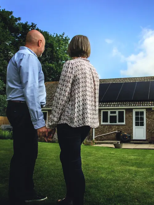 Mr. and Mrs. Firth looking at their new rooftop installation