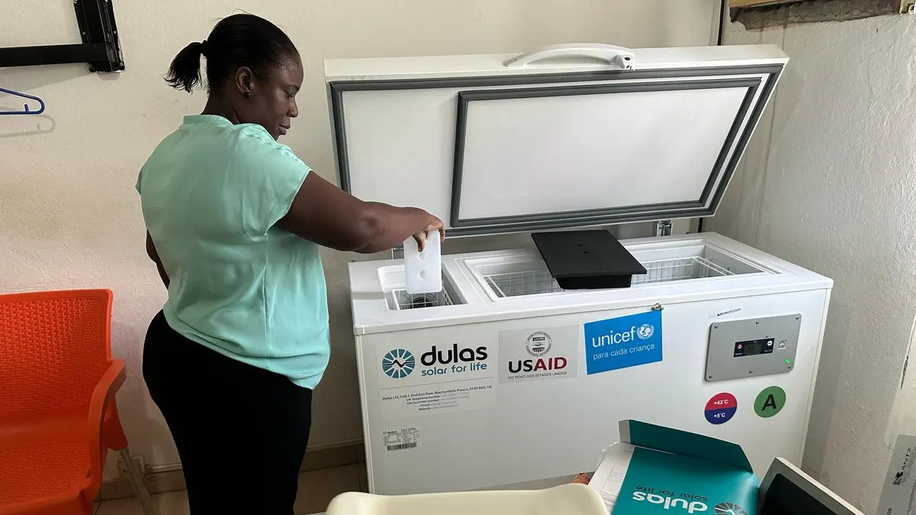 Dulas refrigerator unit being operated by a woman, who is placing an object inside of it.
